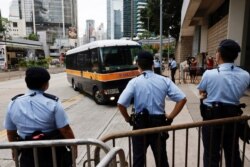 FILE - A prison van arrives High Court on the first day of trial of Tong Ying-kit, the first person charged under a new national security law, in Hong Kong, June 23, 2021.