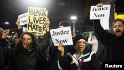 Black Lives Matter protesters chant slogans at the Mall of America light rail station in Bloomington, Minnesota, Dec. 23, 2015.