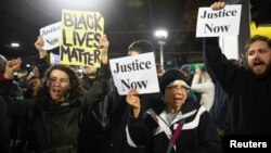 Black Lives Matter protesters chant slogans at the Mall of America light rail station in Bloomington, Minnesota, Dec. 23, 2015.
