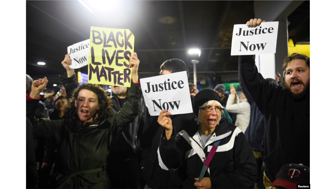 FILE - Black Lives Matter protesters chant slogans at the Mall of America light rail station in Bloomington, Minnesota, Dec. 23, 2015.