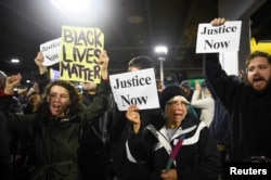 FILE - Black Lives Matter protesters chant slogans at the Mall of America light rail station in Bloomington, Minnesota, Dec. 23, 2015.
