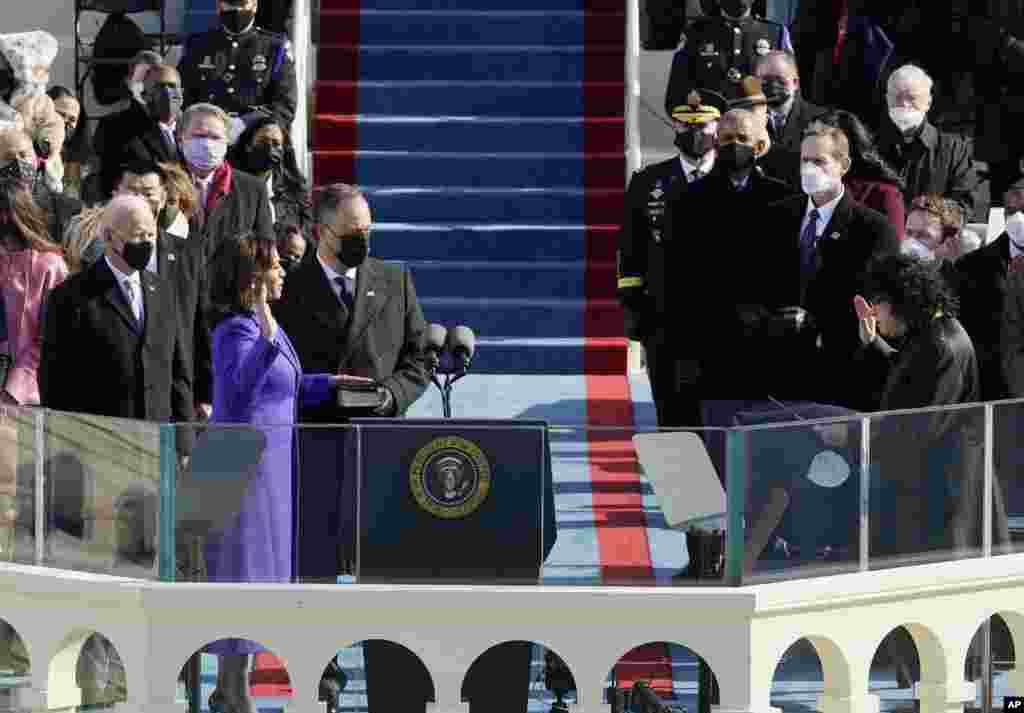 Kamala Harris is sworn in as vice president by Supreme Court Justice Sonia Sotomayor as her husband Doug Emhoff holds the Bible during the inauguration at the Capitol in Washington.