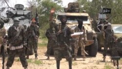 A screengrab taken on July 13, 2014 from a video released by the Nigerian Islamist extremist group Boko Haram and obtained by AFP shows the leader of the Nigerian Islamist extremist group Boko Haram, Abubakar Shekau (C). The head of Nigeria's Boko Haram…