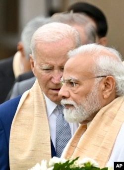 FILE - U.S. President Joe Biden, center, Indian Prime Minister Narendra Modi, and other G20 leaders arrive to pay their tributes at the Rajghat, a Mahatma Gandhi memorial, in New Delhi, India, Sunday, Sept. 10, 2023.