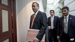 House Speaker John Boehner, who spoke with President Barack Obama Tuesday, arrives for a closed-door meeting with the Republican caucus on Capitol Hill in Washington, Dec. 12, 2012.