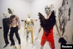 A variety of stage costumes worn by musician David Bowie are seen at the "David Bowie is" Exhibition at the Victoria and Albert Museum in London, March 20, 2013.
