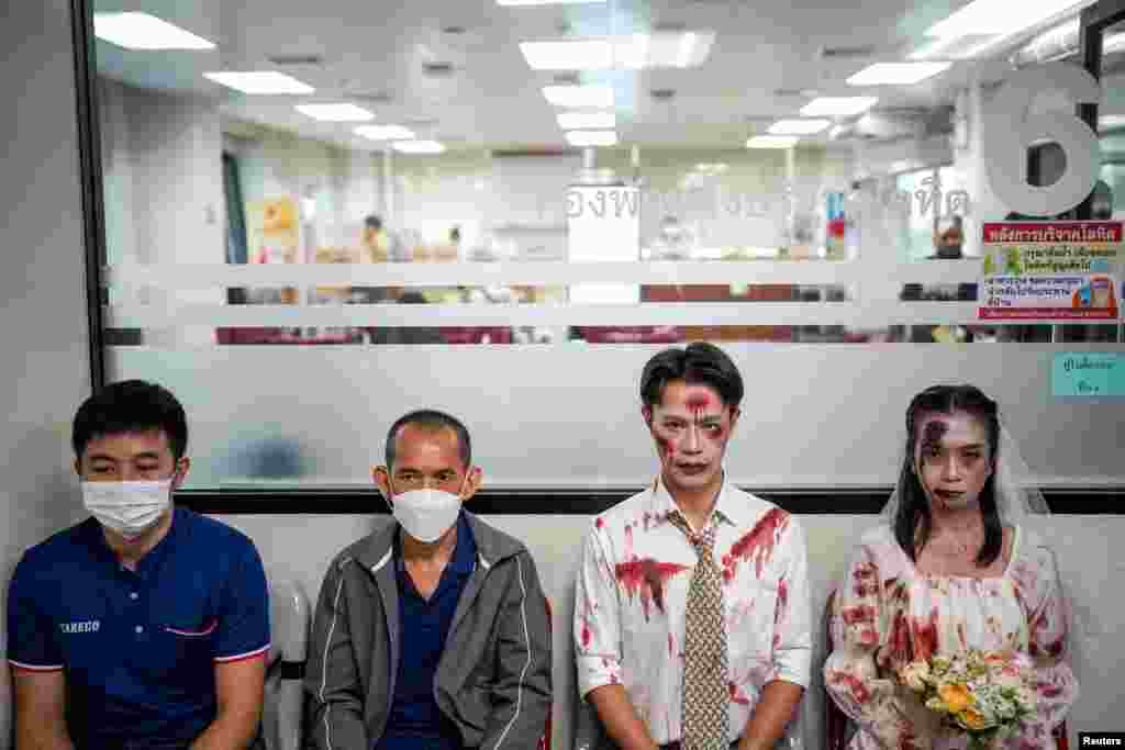 Thai Red Cross staff wearing Halloween costumes pose as people queue to donate blood at the National Blood Center of the Thai Red Cross Society in Bangkok, Thailand.