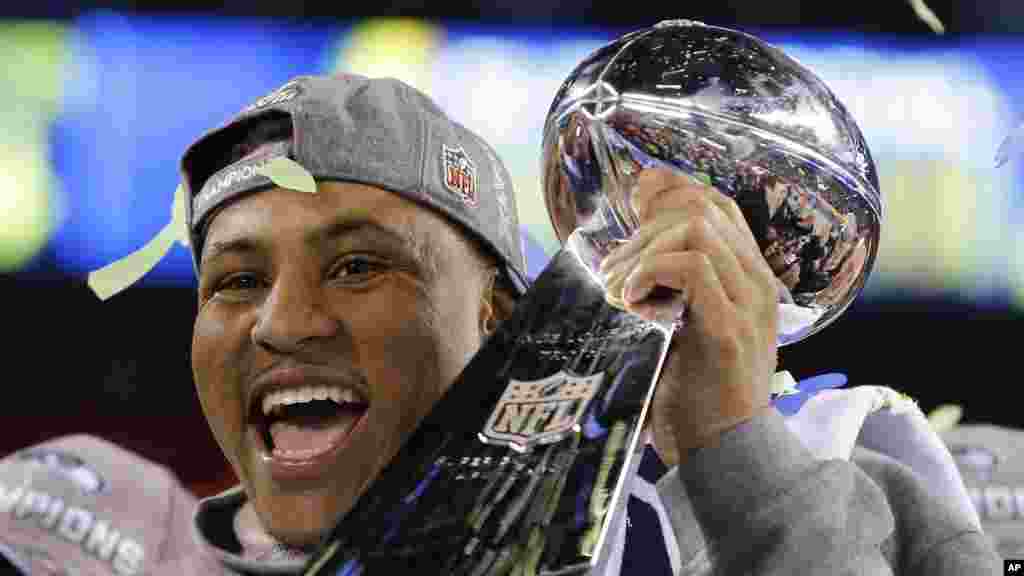 Seattle Seahawks&#39; player holds the Lombardi Trophy after the NFL Super Bowl XLVIII football game