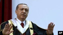 FILE - Turkey's President Recep Tayyip Erdogan addresses an audience after receiving an honorary doctorate from Qatar University, in Doha, Qatar, Dec. 2, 2015.
