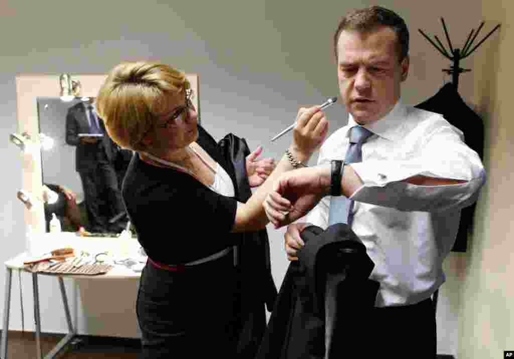 May 18: Russian President Dmitry Medvedev has finishing touches to his makeup before a news conference at a business school in Skolkovo outside Moscow. (AP Photo)