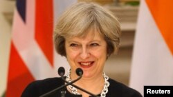 Britain's Prime Minister Theresa May smiles as her Indian counterpart Narendra Modi (unseen) reads a joint statement at Hyderabad House in New Delhi, India, Nov. 7, 2016. 