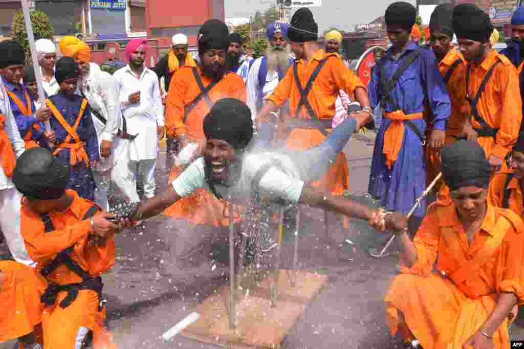 An Indian Nihang, a religious Sikh warrior, deomonstrates Sikh martial arts skills known as &#39;Gatka&#39; during a march to mark the 354th birth anniversary of the Sikh warrior Shaheed Baba Jiwan Singh at the Golden temple in Amritsar.