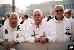 Priests wearing vestments with the effigy of martyred Salvadoran Archbishop Oscar Romero attend a canonization ceremony in St. Peter's Square at the Vatican, Oct. 14, 2018.
