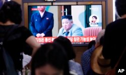 FILE - People watch a TV showing a file image of North Korean leader Kim Jong Un during a news program at the Seoul Railway Station in Seoul, South Korea, July 31, 2019.