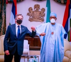 FILE - Nigerian President Muhammadu Buhari and U.S. Secretary of State Antony Blinken salute each other in Abuja, Nigeria, Nov. 18, 2021. (Nigerian Presidency/Handout via Reuters)