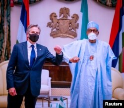 FILE - Nigerian President Muhammadu Buhari and U.S. Secretary of State Antony Blinken salute each other in Abuja, Nigeria, Nov. 18, 2021. (Nigerian Presidency/Handout via Reuters)