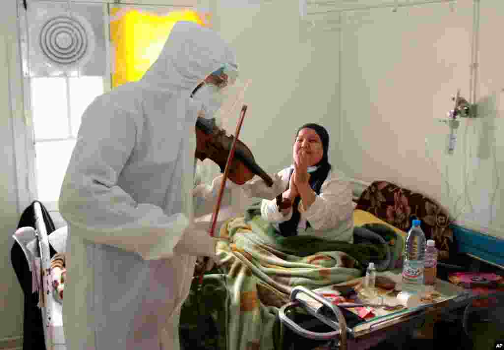 Dr. Mohamed Salah Siala plays the violin for patients in the COVID wards of the Hedi Chaker hospital in Sfax, eastern Tunisia, Feb. 20, 2021.