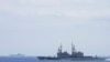 In this photo released by the Taiwan Ministry of National Defense, Taiwanese navy ship Keelung, foreground, a U.S.-made Kidd Class destroyer, monitors the Chinese aircraft carrier Shandong, background, near the Taiwanese waters in September 2023. 