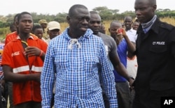 FILE - Uganda's Opposition leader Kizza Besigye, center, meets his supporters after casting his vote at a polling station near his country home in Rukungiri, about 700 kilometres west of Kampala, Feb, 18, 2016.