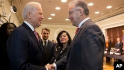 Vice President Joe Biden shakes hands with Rotterdam Mayor Ahmed Aboutaleb ahead of a summit on countering violent extremism in Washington, Feb. 17, 2015.