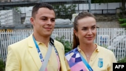 Elina Svitolina posa para una fotografía junto a un atleta ucraniano a bordo de un barco en el desfile flotante en el río Sena durante la ceremonia de apertura de los Juegos Olímpicos de París 2024, el 26 de julio de 2024. (Foto de Clodagh Kilcoyne / POOL)