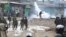 FILE - A supporter of opposition leader Raila Odinga throws a canister of tear gas towards riot police during running battles with police in Kibera Slums in Nairobi, Kenya, Nov. 19, 2017. 