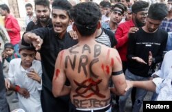 A man with a slogan painted on his back is seen during a protest against a new citizenship law, on the outskirts of Mumbai, India, December 18, 2019. REUTERS/Francis Mascarenhas