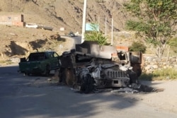 FILE - A burned Humvee is seen along a road in Dashtak, Panjshir province, after the Taliban claimed total control over Afghanistan, saying they had won the key battle for the Panjshir Valley, Sept. 6, 2021.
