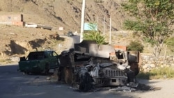 FILE - A burned Humvee is seen along a road in Dashtak, Panjshir province, after the Taliban claimed total control over Afghanistan, saying they had won the key battle for the Panjshir Valley, Sept. 6, 2021.