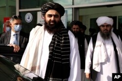 The Taliban delegation led by Amir Khan Muttaqi, the acting foreign minister, front, at Esenboga Airport, arrive in Ankara, Turkey, Oct. 14, 2021.