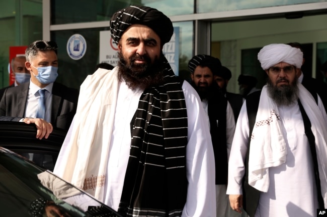 The Taliban delegation led by Amir Khan Muttaqi, the acting foreign minister, front, at Esenboga Airport, arrive in Ankara, Turkey, Oct. 14, 2021.