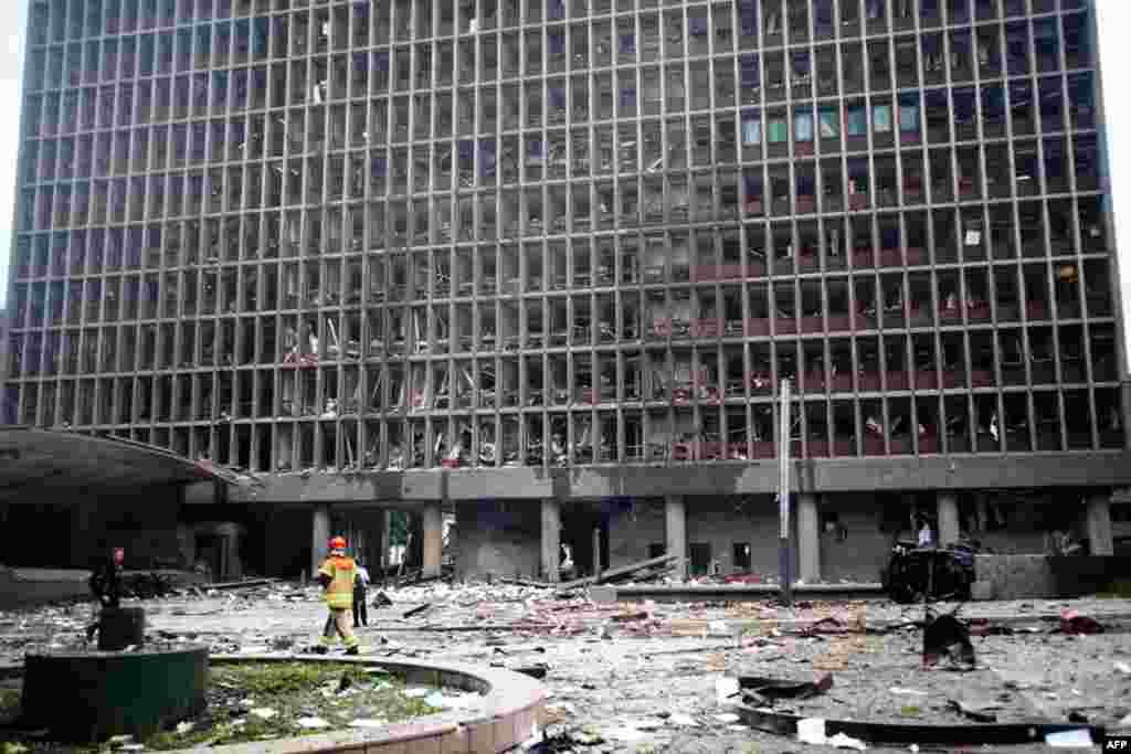 July 22: Debris covers the area outside a building in the centre of Oslo, following an explosion that tore open several buildings including the prime minister's office, shattering windows and covering the street with documents. (AP Photo/Fartein Rudjord)
