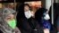 Commuters wear masks on a public bus in downtown Tehran, Iran, Feb. 23, 2020. Iran's Health Ministry raised the death toll from the new coronavirus to eight people in the country.