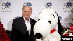 Executive producer Lee Mendelson poses with the Snoopy character to celebrate the 50th anniversary of "A Charlie Brown Christmas" in Beverly Hills, Aug. 5, 2015. Mendelson died on Christmas Day. He was 88.
