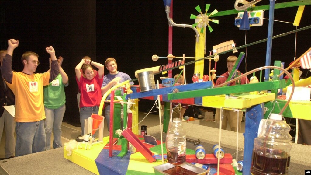 Members of the Theta Tau-Phi Sigma Rho team react to a successful run of their People's Choice Award winning entry in the Rube Goldberg Machine Contest Saturday, Feb. 9, 2002 in West Lafayette, Indiana. (AP Photo/Dave Umberger)