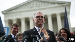 Plaintiff Jim Obergefell holds a photo of his late husband, John Arthur, as he speaks to members of the media after the U.S. Supreme Court ruled that same-sex couples have the right to marry in all 50 states, outside the Supreme Court in Washington, June 