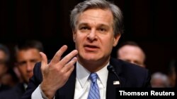 FILE PHOTO: FBI Director Christopher Wray testifies before a Senate Homeland Security and Governmental Affairs Committee