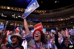 Delegates cheer as Democratic Presidential candidate Hillary Clinton appears on the screen during the second day session of the Democratic National Convention in Philadelphia, July 26, 2016.