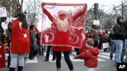 Turkish citizens from France demonstrate in front of the Senate in Paris, Jan. 23, 2012, to protest against a law that would make it a crime to deny "genocide" in Armenia.