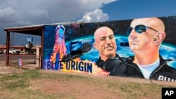 The side of a building in Van Horn, Texas, is adorned with a mural of Blue Origin founder Jeff Bezos on Saturday, July 17, 2021, just days before Bezos launched into space from the Blue Origin spaceport about 25 miles outside of the West Texas town. (AP Photo)