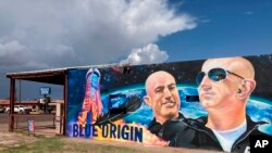 The side of a building in Van Horn, Texas, is adorned with a mural of Blue Origin founder Jeff Bezos on Saturday, July 17, 2021, just days before Bezos launched into space from the Blue Origin spaceport about 25 miles outside of the West Texas town. (AP P