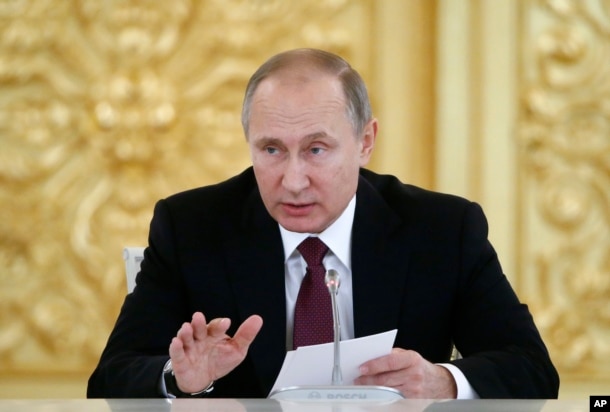 FILE - Russian President Vladimir Putin delivers a speech during a session of the Council for Civil Society and Human Rights in Moscow, Dec. 8, 2016.