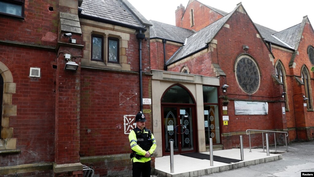 A police officer stands outside Didsbury mosque in Manchester, Britain, May 24, 2017.