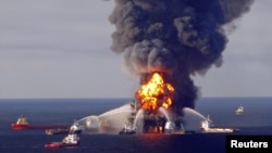 Fire boat response crews battle the blazing remnants of the offshore oil rig Deepwater Horizon, off Louisiana, in this April 21, 2010 handout image. 