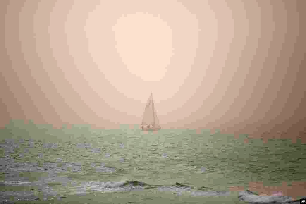 A boat makes its way through a sandstorm in the Mediterranean Sea near Tel Aviv, Israel.