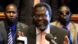 South Sudan's ruling party has voted to allow rebel leader Riek Machar (center) and other officials to return to their high-level party positions. 