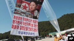 Para pengungsi dan pembelot Korea Utara bersiap untuk meluncurkan balon dan poster bergambar pemimpin Korea Utara Kim Jong-un, Kim Jong-il dan Kim Il-sung yang berisi kecaman anti-pemerintah Korea Utara, dekat pos unifikasi di Paju, Korea Selatan, 4 Oktober 2013 (Foto: dok). Korea Utara menolak usulan Korea Selatan untuk melanjutkan program reuni keluarga, Kamis (9/1).