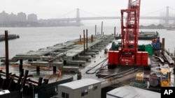 FILE - A half-finished dock for a fleet of ferries is seen in the Brooklyn Navy Yard in New York, March 28, 2017. The first of 20 high-tech, light aluminum ferries costing nearly $4 million each were set to arrive in New York in early April.