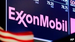 FILE - In this April 23, 2018, file photo, the logo for ExxonMobil appears above a trading post on the floor of the New York Stock Exchange. Exxon Mobil is making a big bet on the future of exporting natural gas. Exxon and Qatar Petroleum announced…