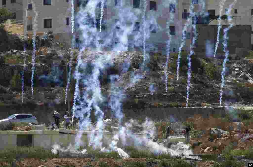 Israeli troops fire tear gas canisters at Palestinians from Birzeit University during demonstration in support of Palestinian prisoners held in Israeli jails at checkpoint Beit El near the West Bank city of Ramallah.